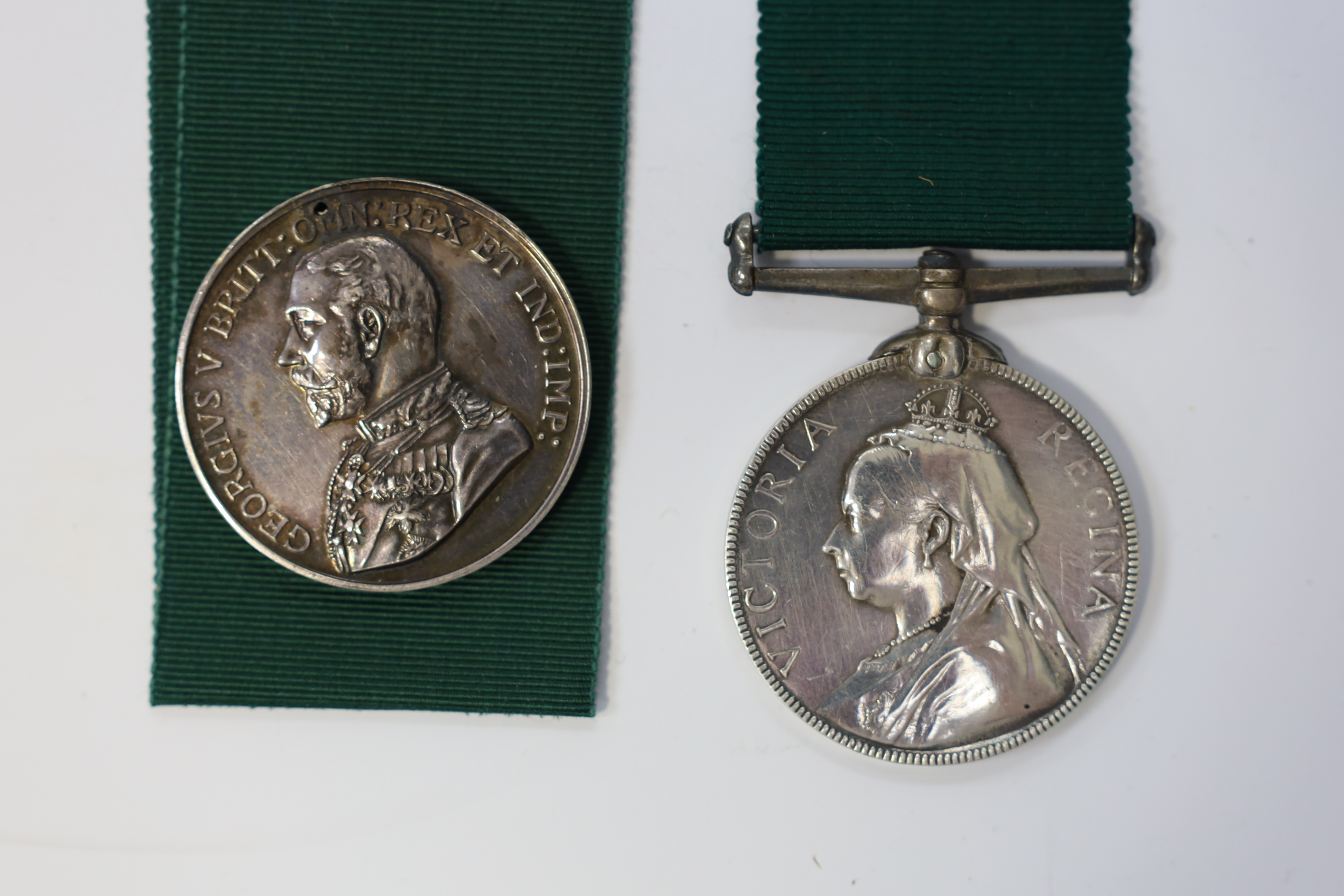 Four assorted Service medals; Vict unnamed Volunteer Long Service medal; GV Colonial Auxiliary Forces Long Service medal (disc only) to E.S.Ware; ERII ISM to Thomas Edward Downes; ERII ISM to William Henry Sharratt. Cond